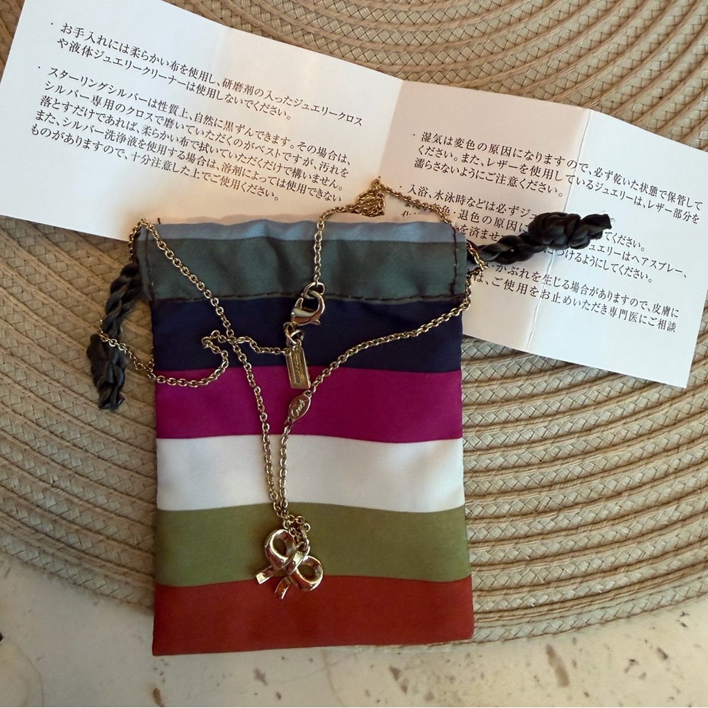 Coach Gold-Tone Crystal Bow Necklace with Legacy Striped Pouch and Coach Logo - Picture 5 of 7